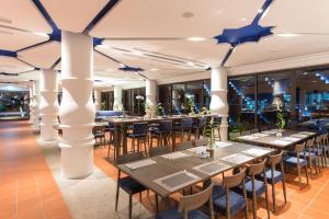 a row of tables in a restaurant with blue stars on the ceiling at Aksorn Rayong, The Vitality Collection - SHA PLUS in Klaeng