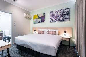 a hotel room with a bed and a desk at Nightcap at Wanneroo Tavern in Wanneroo