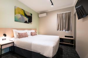 a hotel room with a bed and a television at Nightcap at Wanneroo Tavern in Wanneroo +52 photos