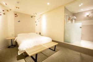 A bed or beds in a room at Walker Hotel. Ximen