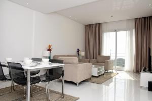 a white living room with a table and a couch at Code housing - Al Bedaa- Family only in Kuwait