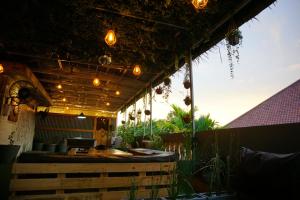 a patio with a table and lights on it at Kokos Hostel Padang City in Padang