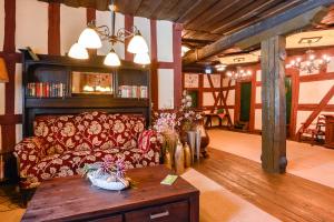 a living room with a couch and a table at DER SCHWAN Hotel & Restaurant in Schwanstetten