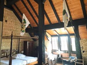 a bedroom with a bed and flags in a building at Fewo GERICHTSSTUBE im Rittergut bei Dresden für 2 Erw und 4 Kids in Wachau