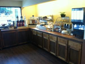 a kitchen with a counter with a counter top with food at The Redwood Riverwalk, a boutique hotel in Fortuna