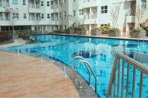 a large swimming pool with blue water in a building at Wood Hotel Bandung in Bandung