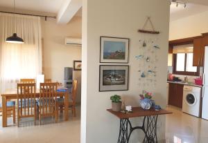 a living room and a kitchen with a dining room at Ithaki House in Lyso