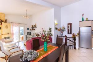 a kitchen and a living room with a table at Villa Efi in Skala Rachoniou