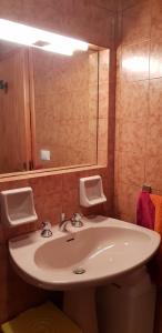 a bathroom with a sink and a mirror at GRAZIOSA BIFAMILIARE AD ASIAGO con giardino privato in Asiago