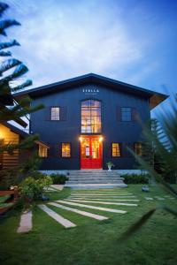 a large building with a red door and stairs at Stella Moonlight Khaoyai in Pong Talong