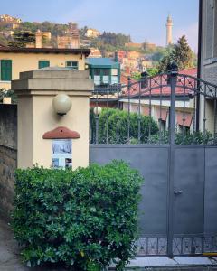 a gate with a building with a mushroom on it at Le Residenze dei Serravallo in Trieste