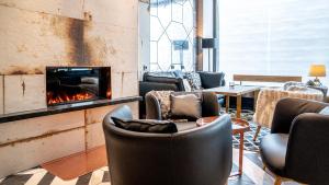 a living room with chairs and a fireplace at Solo Sokos Hotel Turun Seurahuone in Turku