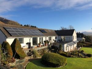 a house with solar panels on the roof at The Bungalows Guesthouse in Threlkeld