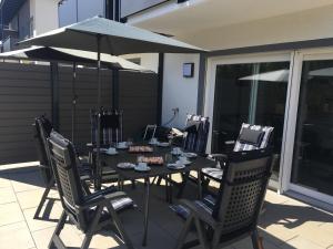 a table with chairs and an umbrella on a patio at Haus Schladming in Schladming