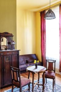 a living room with a couch and a table and chairs at Hostel, Pokoje gościnne Mleczarnia - Ozonowane in Wrocław +95 photos