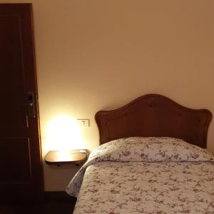 
a bedroom with a bed and a lamp at Affittacamere Mazzini 78 in Grosseto
