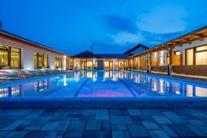 a swimming pool in a villa at night at DorEsz Wellness Panzió in Újhartyán