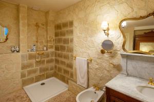 a bathroom with a sink and a toilet and a shower at Hôtel Boutique Saint-Louis in Lisieux +38 photos