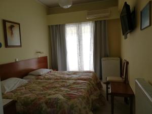Postel nebo postele na pokoji v ubytování Amvrakia Hotel