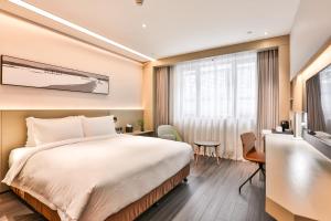 Postel nebo postele na pokoji v ubytování Harbin Week Inn Hotel + 40 fotografií
