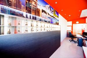 an office with an orange wall with a tennis ball display at Aparthotel Autosole in Estepona