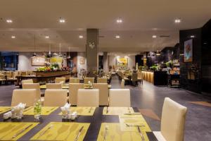 a restaurant with tables and chairs and a bar at Terracotta Hotel & Resort Dalat in Da Lat