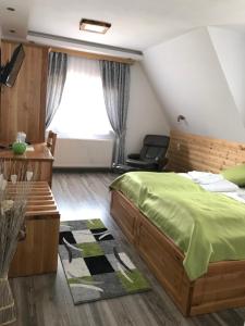a bedroom with a bed and a chair and a window at Rustic Inn River in Plitvička Jezera