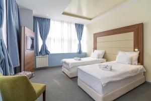 Katil atau katil-katil dalam bilik di Privilege Suites by Central Park