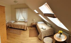 a attic bedroom with two beds and a window at Villa Mechelinka in Mechelinki +35 photos