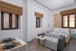 a living room with a couch and a table at Alley 7, Old Town in Rhodes Town