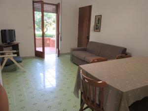 un soggiorno con tavolo e divano di Nicoletta's House - zona le dune - Porto Cesareo a Porto Cesareo