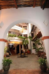 an archway in a building with potted plants at Hostal Recoleta Sur in Sucre