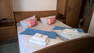 a bed with three pillows and towels on it at Da Carla in Rüdesheim am Rhein +7 photos