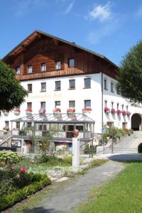 a large white building with a wooden roof at Rinchnacher Hof in Rinchnach