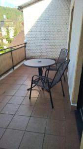 a table and two chairs on a balcony at Da Carla in Rüdesheim am Rhein