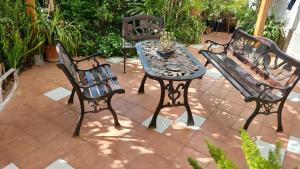 three benches and a table on a patio at Appartamento La Follicara in Anacapri