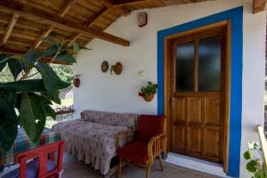 a porch with a chair and a door at KARABURUN KÖYEVİ Pansiyon in Saip
