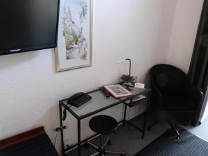 a desk with a chair and a computer on it at Hotel Jägerhof in Mayen