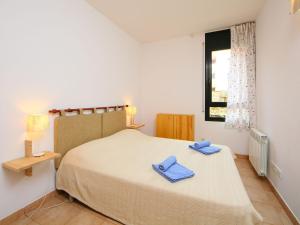 リョレート・デ・マルにあるApartment Gardenia by Interhomeのベッドルーム1室(青いタオル付きのベッド1台付)
