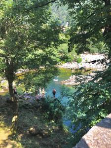 a group of people standing in a river at Camping & Resort Valle Romantica in Cannobio
