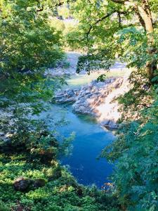 a view of a river between two trees at Camping & Resort Valle Romantica in Cannobio