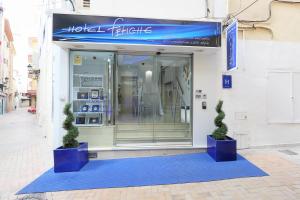 a store front with two potted plants in front of it at Hotel Fetiche Alojamiento con Encanto in Benidorm