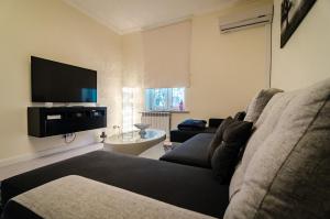 a living room with a couch and a flat screen tv at Apartment Evita in Sopot