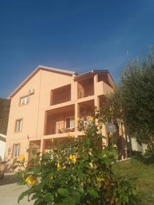 a building with a tree in front of it at Apartman Simona in Tivat