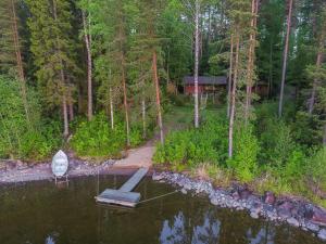 an aerial view of a lake with a boat in the water at Holiday Home Länsiranta by Interhome in Hirvikoski