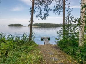 a path leading to a dock on a lake at Holiday Home Länsiranta by Interhome in Hirvikoski