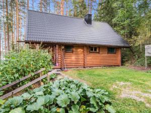 a log cabin in the woods with a fence at Holiday Home Iltarusko by Interhome in Vuoriniemi