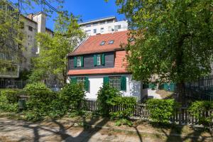 a house with a red roof and green windows at Vila Selena in Ljubljana