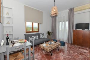 a living room with a couch and a table at V & G Cozy Apartments in Kissamos