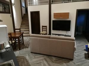 a living room with a couch and a flat screen tv at Apartamento La Sierra in La Codosera